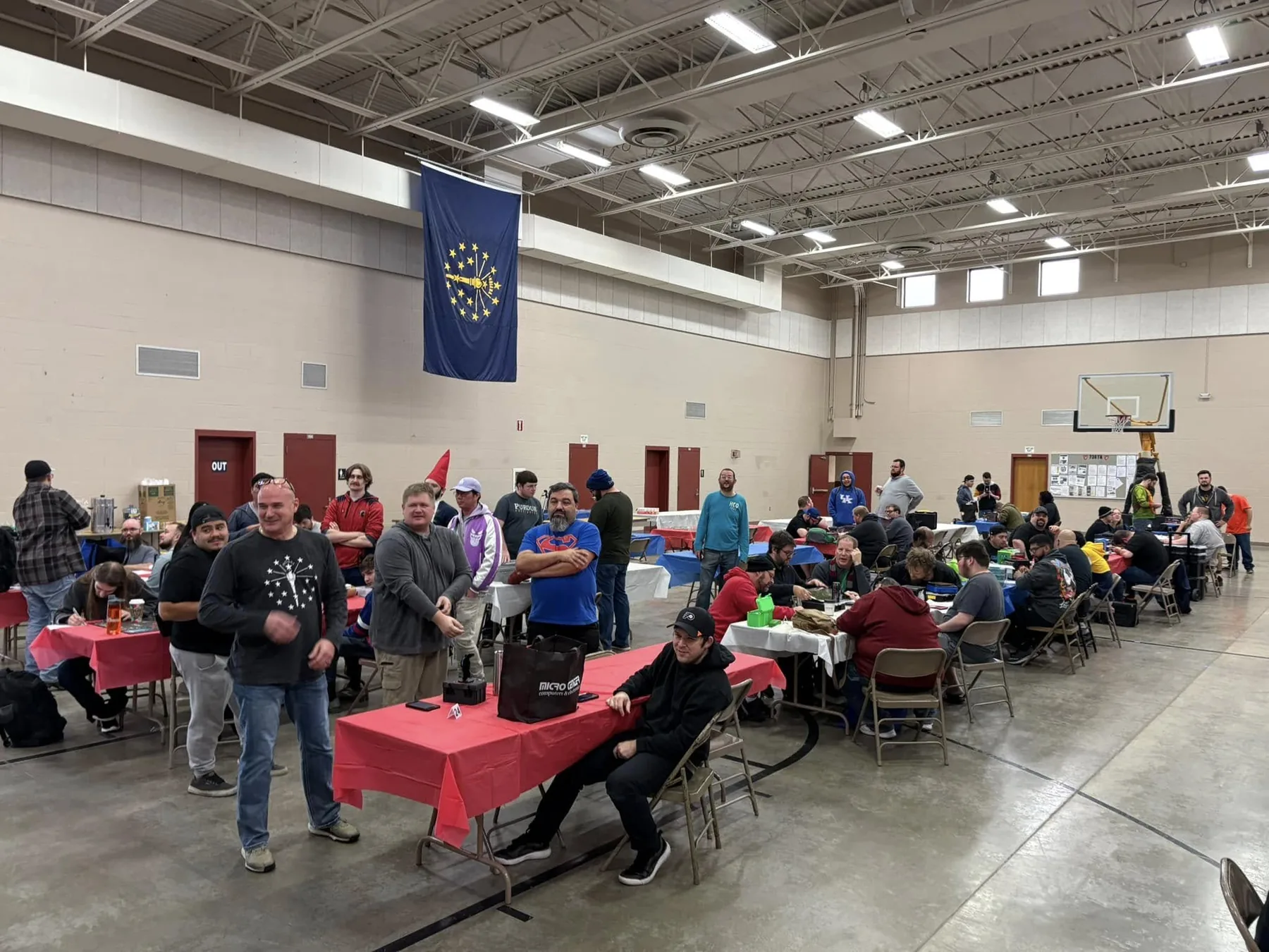 Players at tables filling the National Guard Armory hall during a Red, White, and Clix HeroClix weekend.